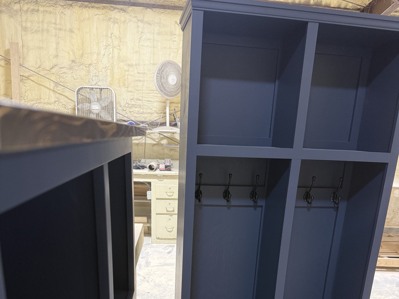 A navy mudroom locker built by hand in The Wooden Nest workshop in Tennessee