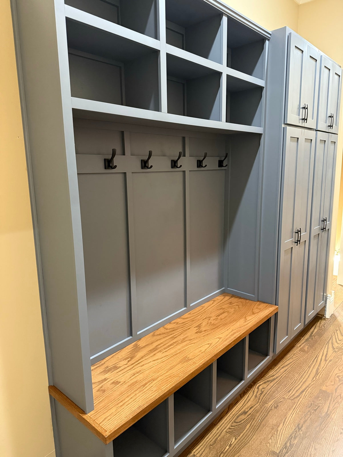 Grey custom halltree with an oak bench and matching locker cabinet