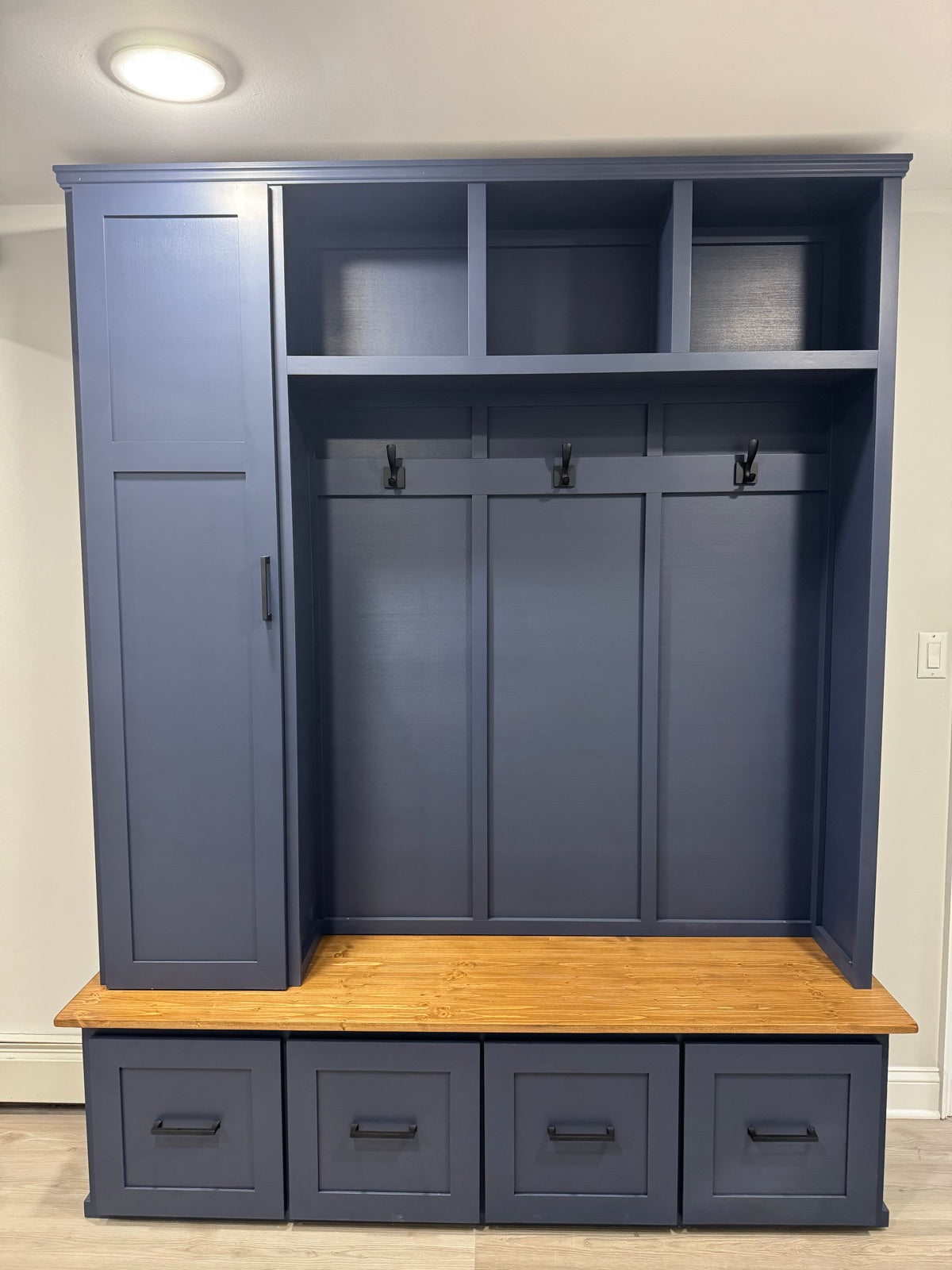Navy custom mudroom halltree with storage drawers and a side locker