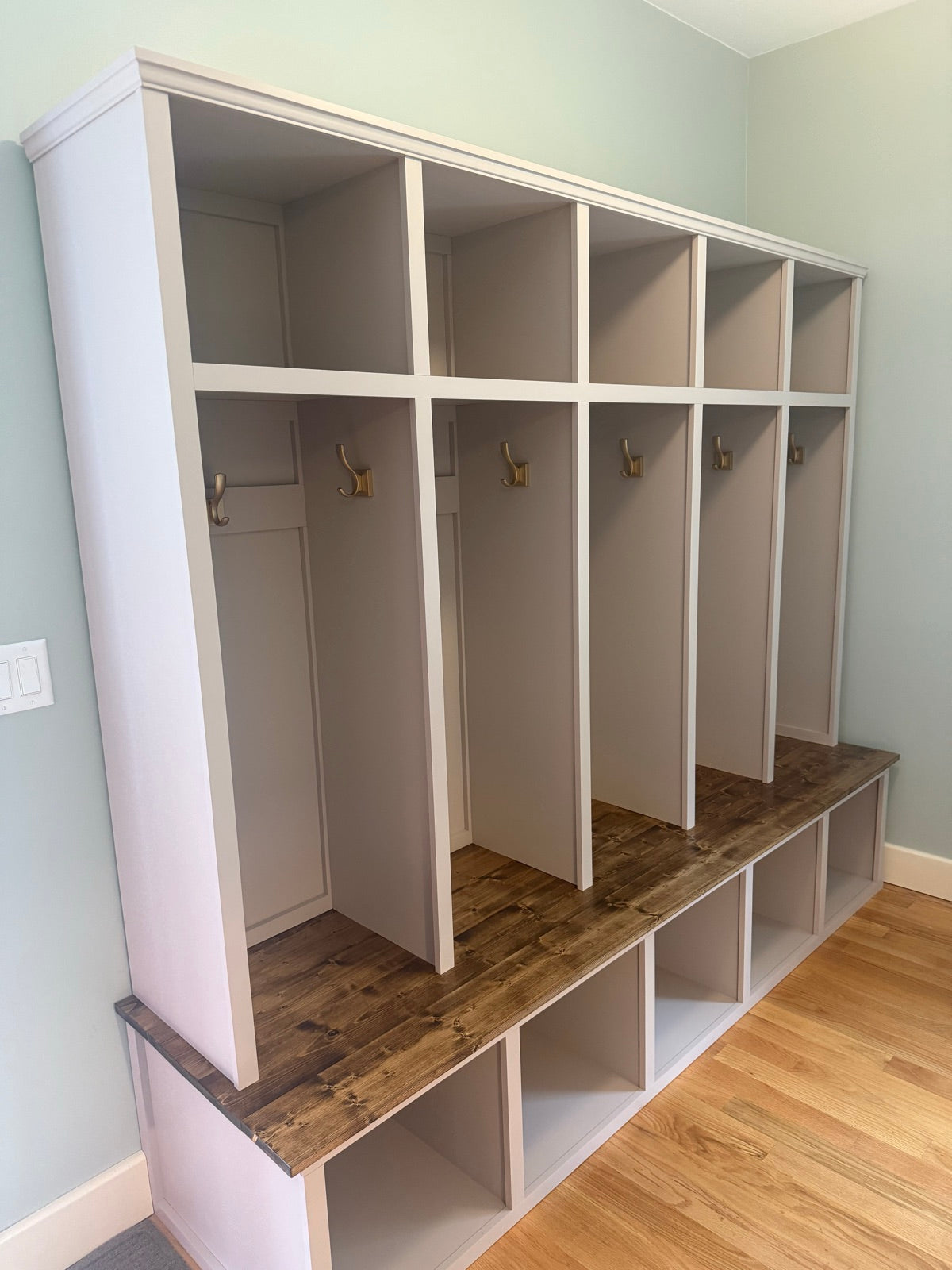 Greige open lockers with a stained bench top
