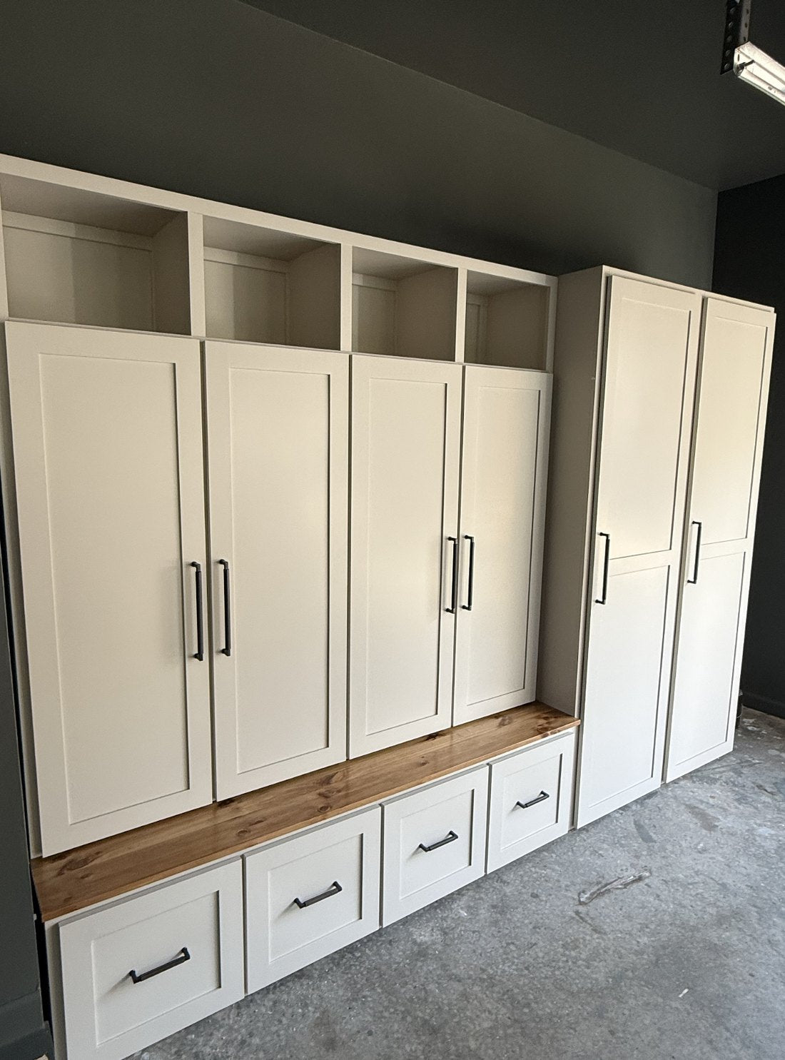 A custom cream mudroom locker and bench built by The Wooden Nest